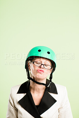 Buy stock photo Glasses, helmet and senior woman pouting in studio isolated on green background for cycling. Attitude, face and safety with serious old person on mock up space for fashion, fitness or vision