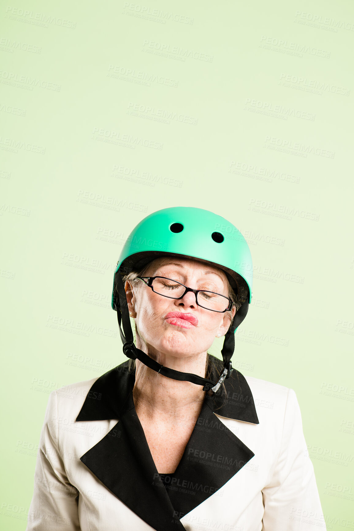 Buy stock photo Glasses, helmet and senior woman pouting in studio isolated on green background for cycling. Attitude, face and safety with serious old person on mock up space for fashion, fitness or vision