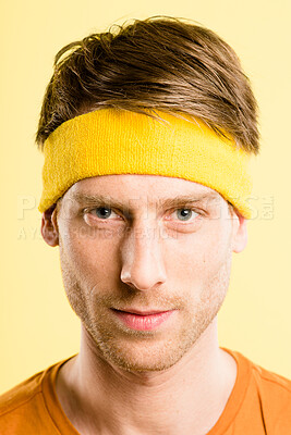 Buy stock photo Shot of a handsome young man standing alone in the studio and posing while wearing a headband