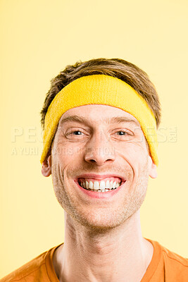 Buy stock photo Shot of a handsome young man standing alone in the studio and posing while wearing a headband