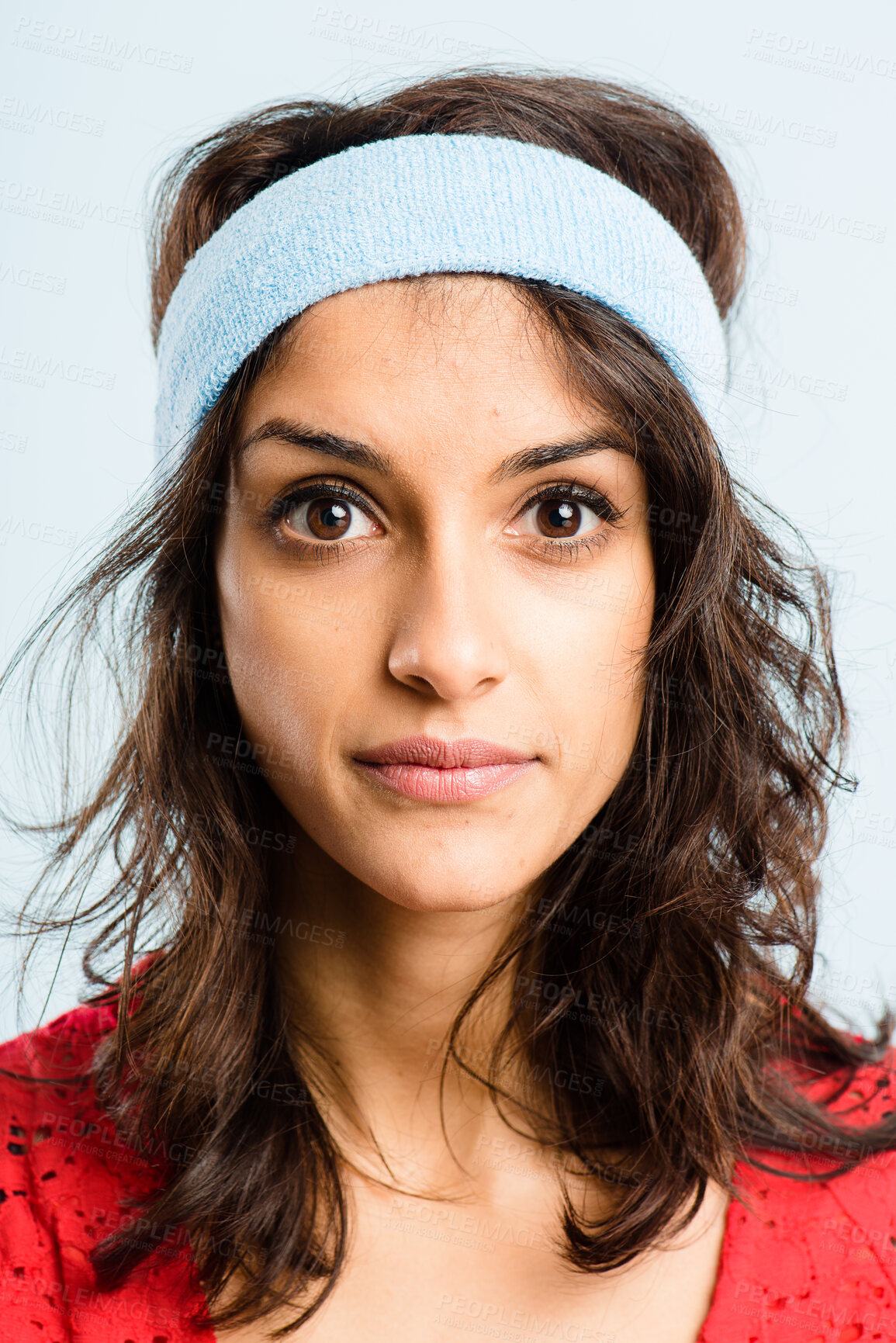 Buy stock photo Retro, fitness and portrait of Indian woman with headband, serious and workout coach for gym in studio. Pride, face and girl with vintage style, exercise fashion and confidence on blue background.