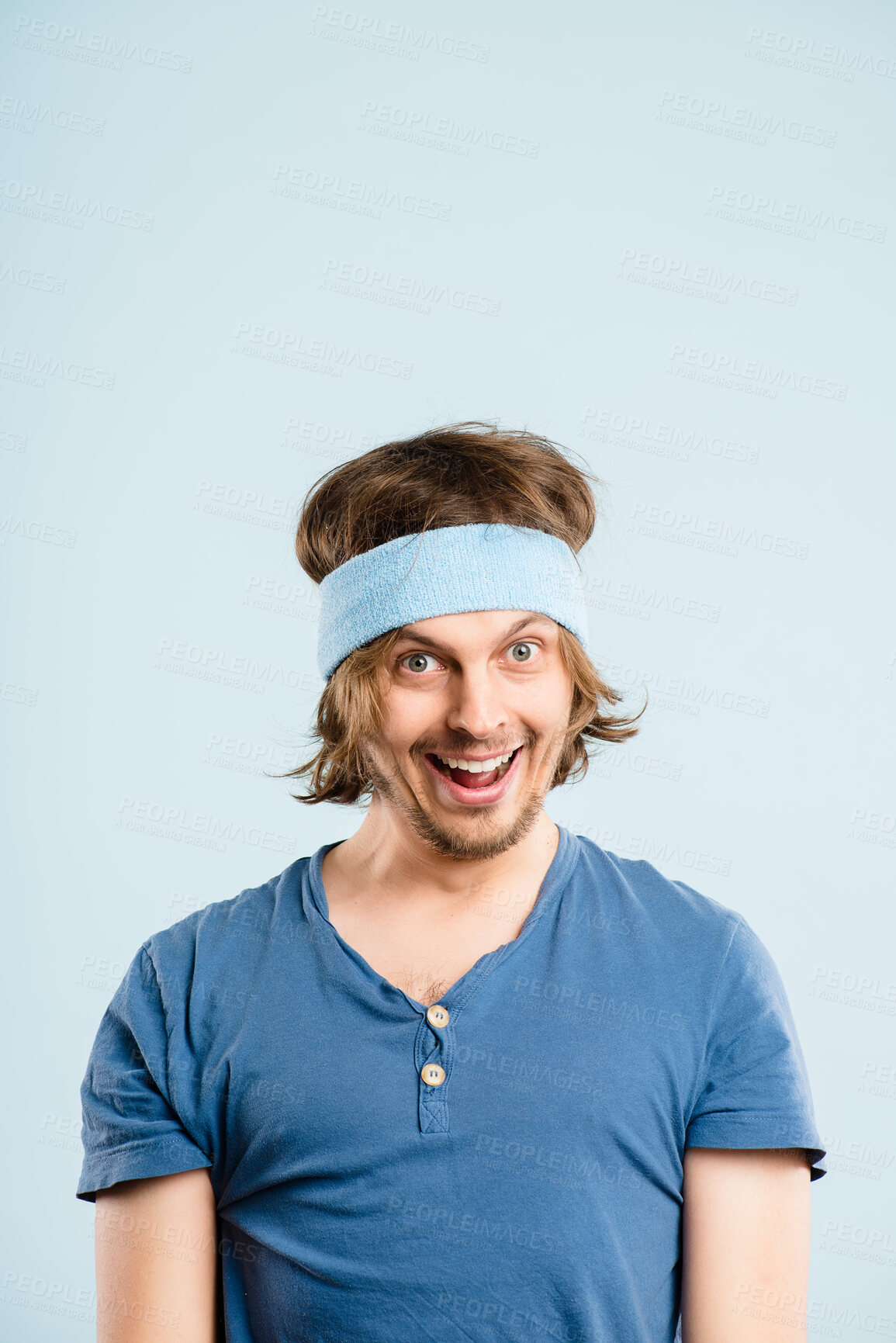 Buy stock photo Crazy, fitness and portrait of man with headband, retro fashion and gym workout in studio mockup. Smile, funny face and male person with vintage style, exercise or confidence on blue background space