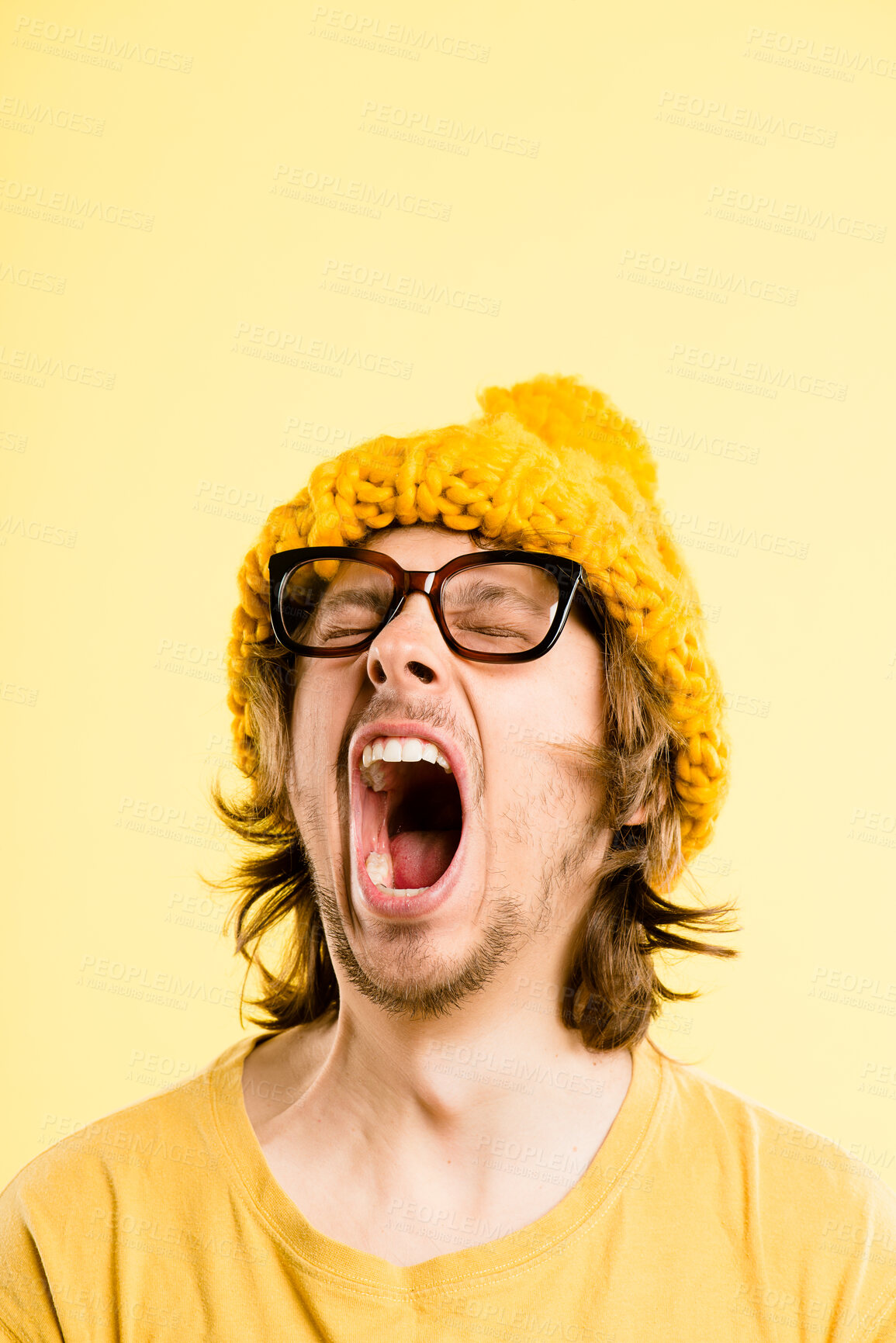 Buy stock photo Man, tired and yawn with winter hat, fashion and sleepy with funky beanie style in studio. Nerd, yell face and glasses with hipster, rest and cool accessory with yellow background, break and mockup