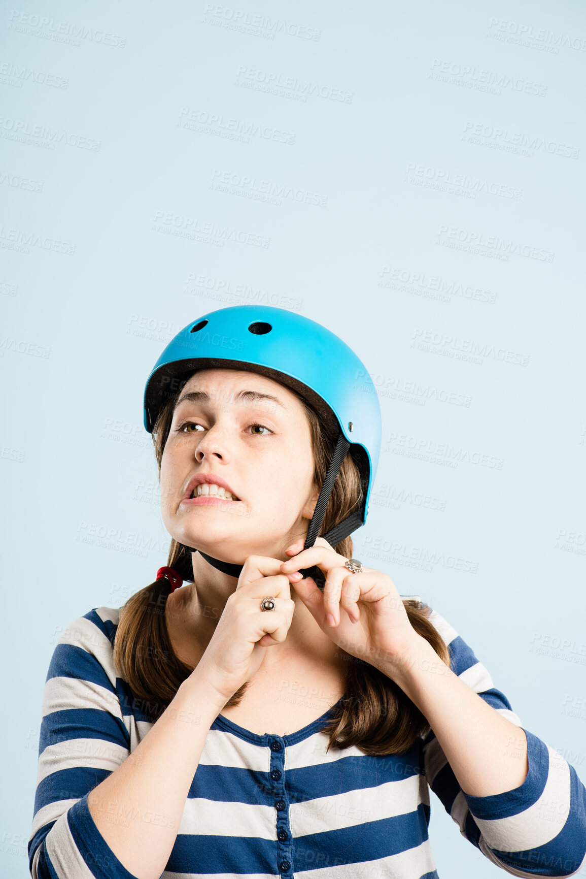 Buy stock photo Woman, bicycle helmet and studio with safety, gear and trip with mockup space by blue background. Person, thinking and ready with hardhat for eco friendly transportation on journey, travel or cycling