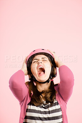 Buy stock photo Scream, studio and woman with cycling helmet, stress and anxiety in retro fashion with mockup space. Shout, anger and frustrated girl with vintage style, bicycle gear and tantrum on pink background.