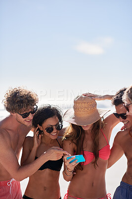 Buy stock photo Social media, freedom and friends on the beach with a phone to post a status update while on vacation together. Mobile, summer and a group of young people outdoor in nature for holiday travel