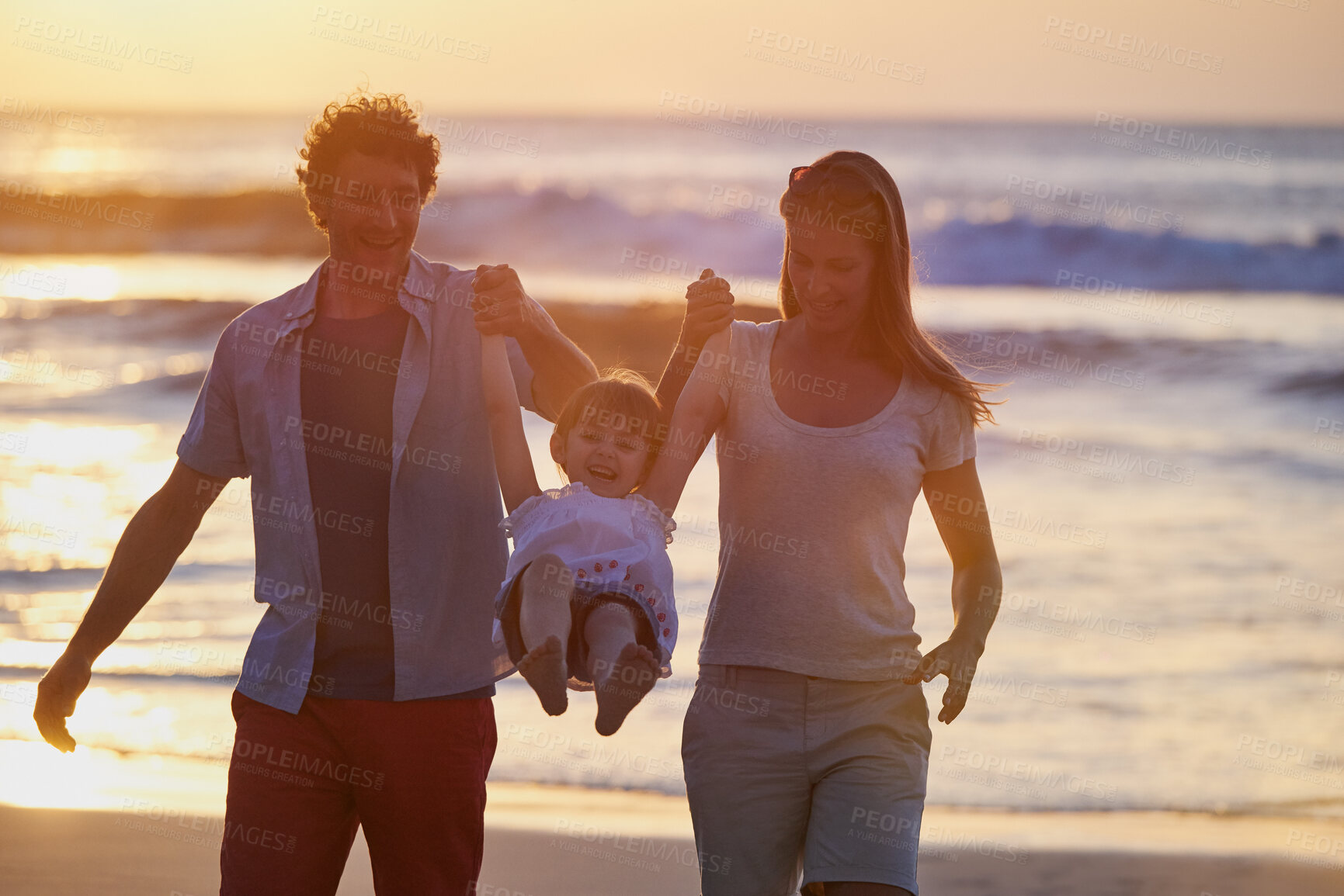 Buy stock photo Play, girl and parents holding hands on beach for fun, travel holiday and bonding together on tropical adventure. Mom, dad and child on happy family vacation with ocean, support and island sunset