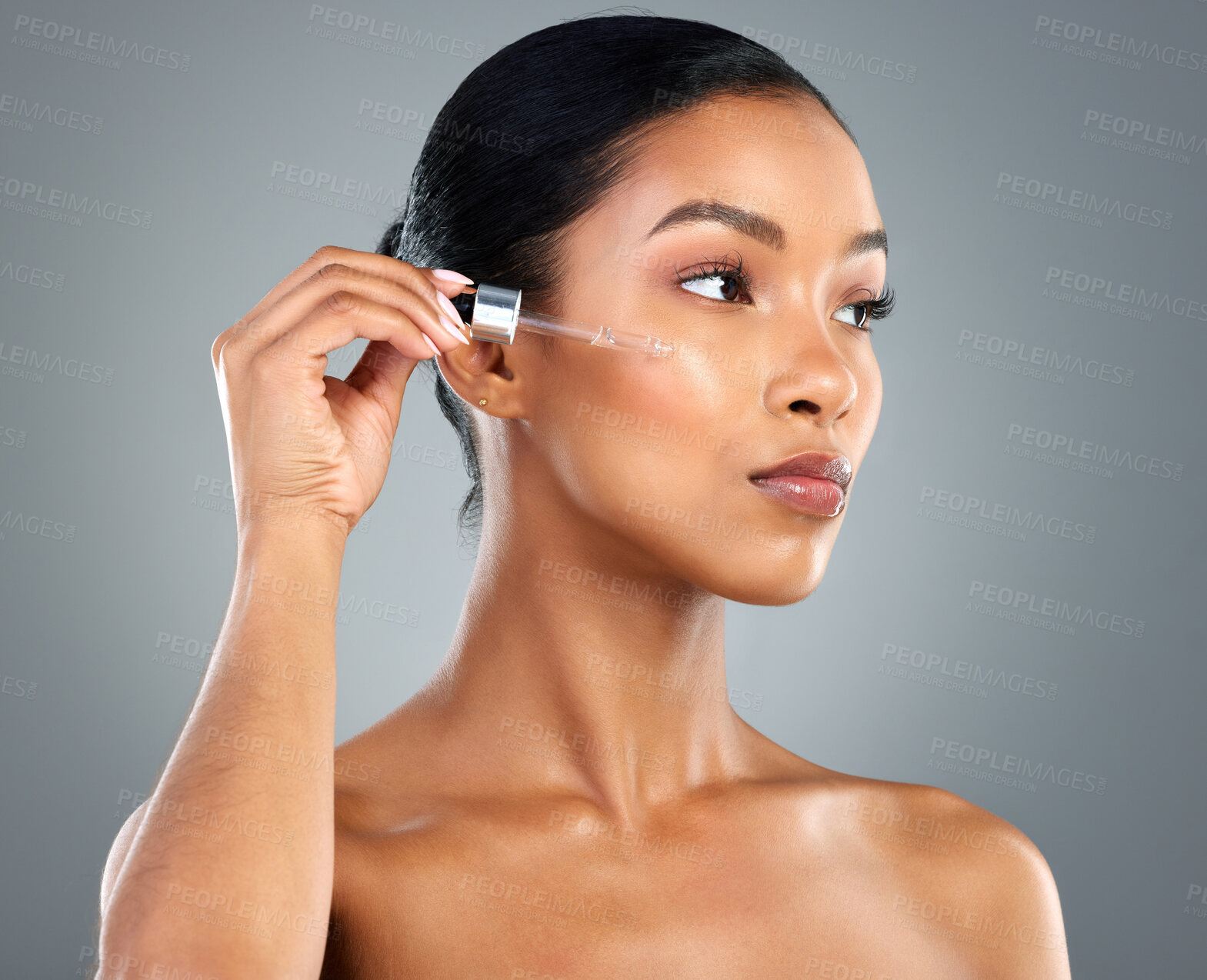 Buy stock photo Woman, face and serum with beauty in studio for collagen treatment, skin hydration and skincare. Liquid, dropper and cosmetics product with hyaluronic acid, retinol and wellness on gray background