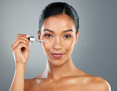 Buy stock photo Girl, portrait and serum with beauty in studio for collagen treatment, skin hydration and skincare. Mockup, happy and cosmetics product with hyaluronic acid, retinol and wellness on gray background