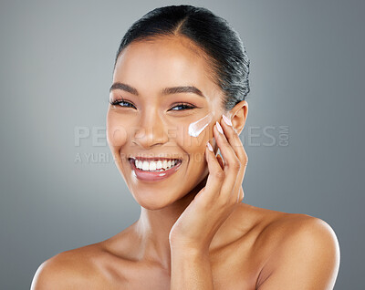 Buy stock photo Woman, portrait and creme with beauty in studio for collagen treatment, hydration and skincare. Sunscreen, happy and cosmetics product with hyaluronic acid, retinol and wellness on gray background