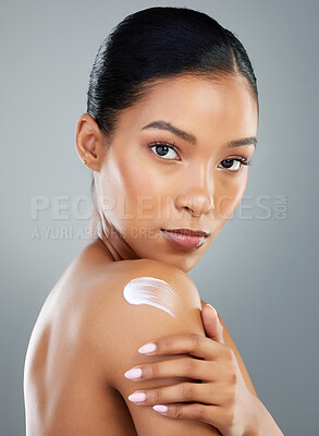 Buy stock photo Woman, portrait or shoulder with cream for skincare, cosmetics or SPF on a gray studio background. Young, female person or model with moisturizer, lotion or creme on soft skin, glow or smooth texture