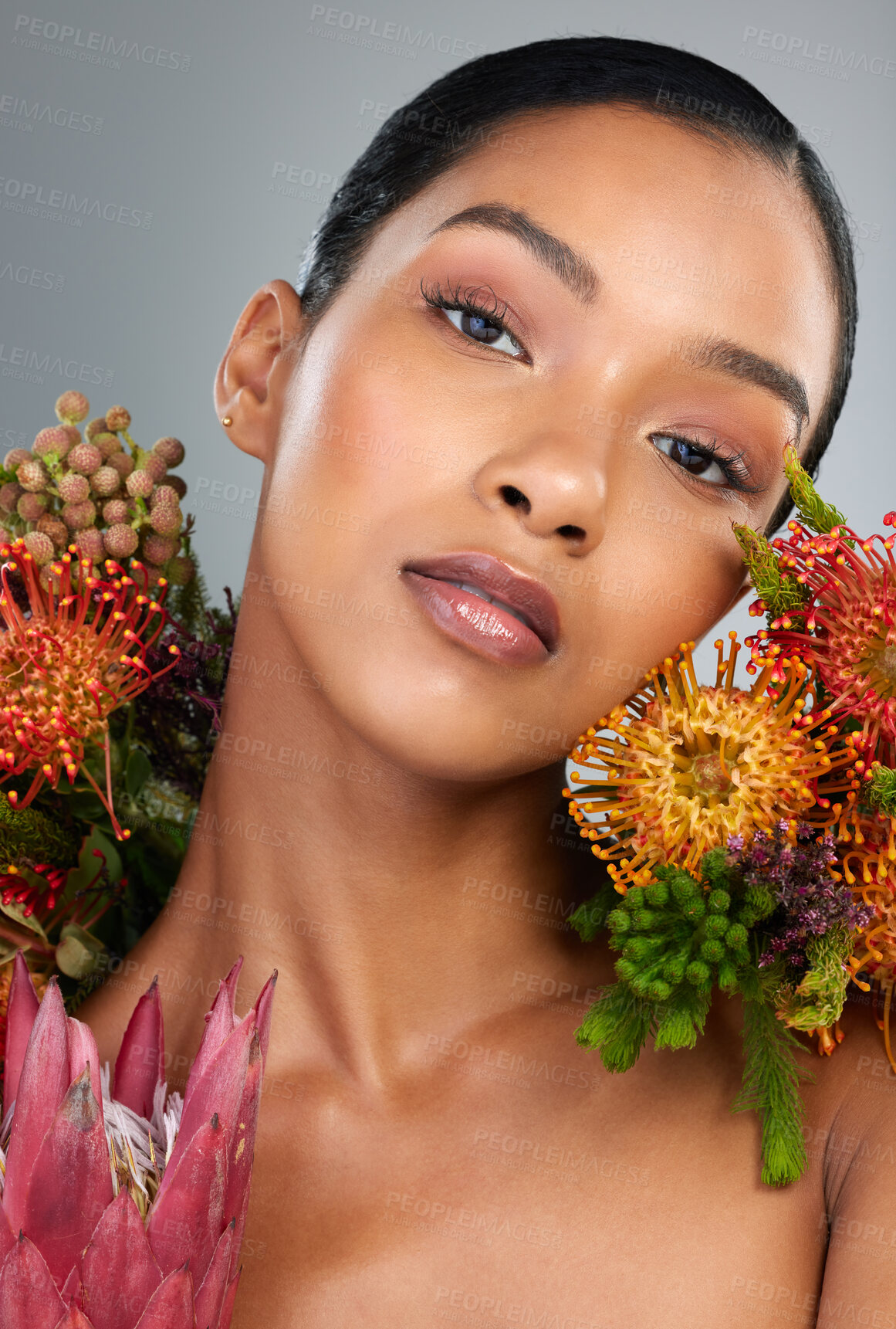 Buy stock photo Woman portrait, flowers and skincare in studio, blossom and organic treatment on gray background. Female person, vegan facial and confident for natural dermatology, fynbos and sustainable beauty