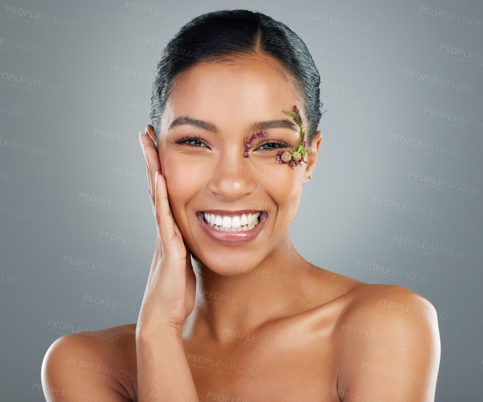 Buy stock photo Woman, flowers and cosmetics in studio portrait for makeup, happy and leaves by eye by background. Girl, person and model for organic skincare in spring, floral plants or transformation in Costa Rica