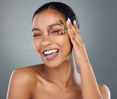 Buy stock photo Woman, flowers and happy with cosmetics in studio portrait, makeup or leaves by eye by background. Girl, person and model for organic skincare in spring, floral plants or transformation in Costa Rica