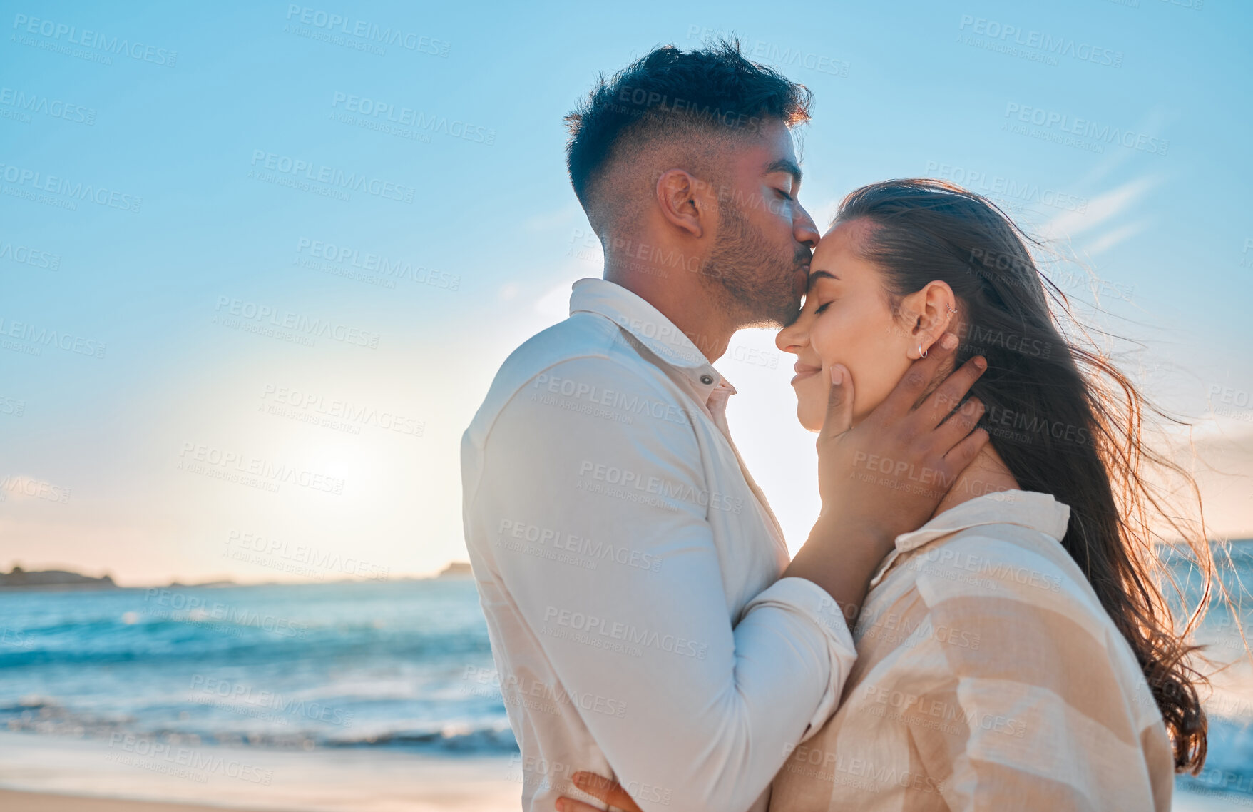 Buy stock photo Kiss, beach and couple hugging for travel, getaway or holiday for romance together with care. Love, travel and young man and woman embracing by tropical ocean on date on seaside summer weekend trip.