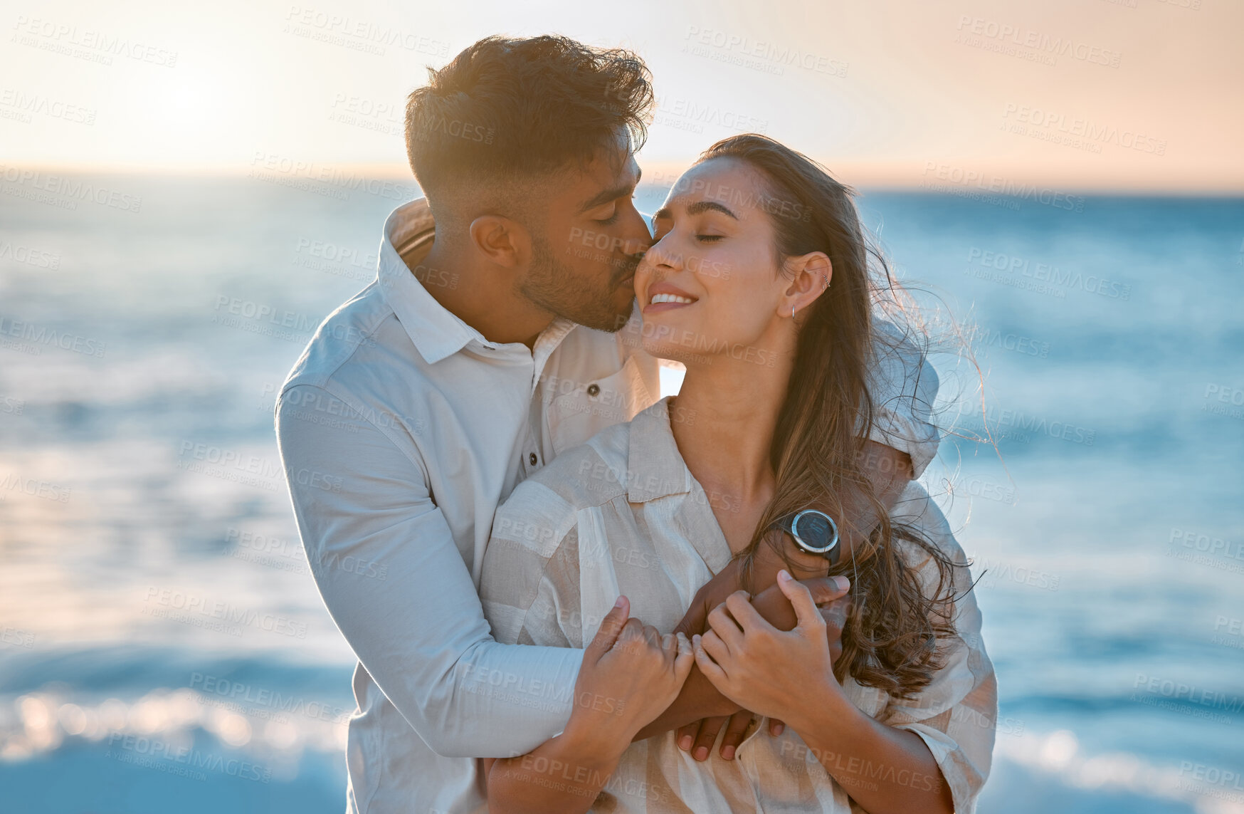 Buy stock photo Shot of a young couple spending time together at the beach