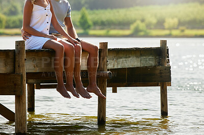 Buy stock photo Couple together in nature, relax by lake and summer, travel and adventure, love and care outdoor. People in relationship, trust and bonding on vacation, man and woman sitting on jetty with freedom