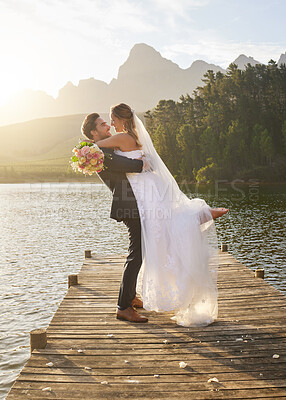 Buy stock photo Romance, love and a married couple on a pier over a lake in nature with a forest in the background after their ceremony. Wedding, love and water with a young couple in celebration of marriage outdoor