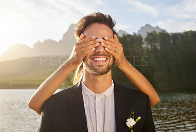 Buy stock photo Love, wedding and surprise with a married couple by a lake, in celebration of a ceremony of tradition. Romance, marriage or hands over face with a bride and groom playing or joking together outdoor