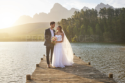 Buy stock photo Love, married or romance with a bride and groom on a pier over a forest lake in nature after their ceremony. Wedding, love and water with a young couple in celebration of their marriage outdoor
