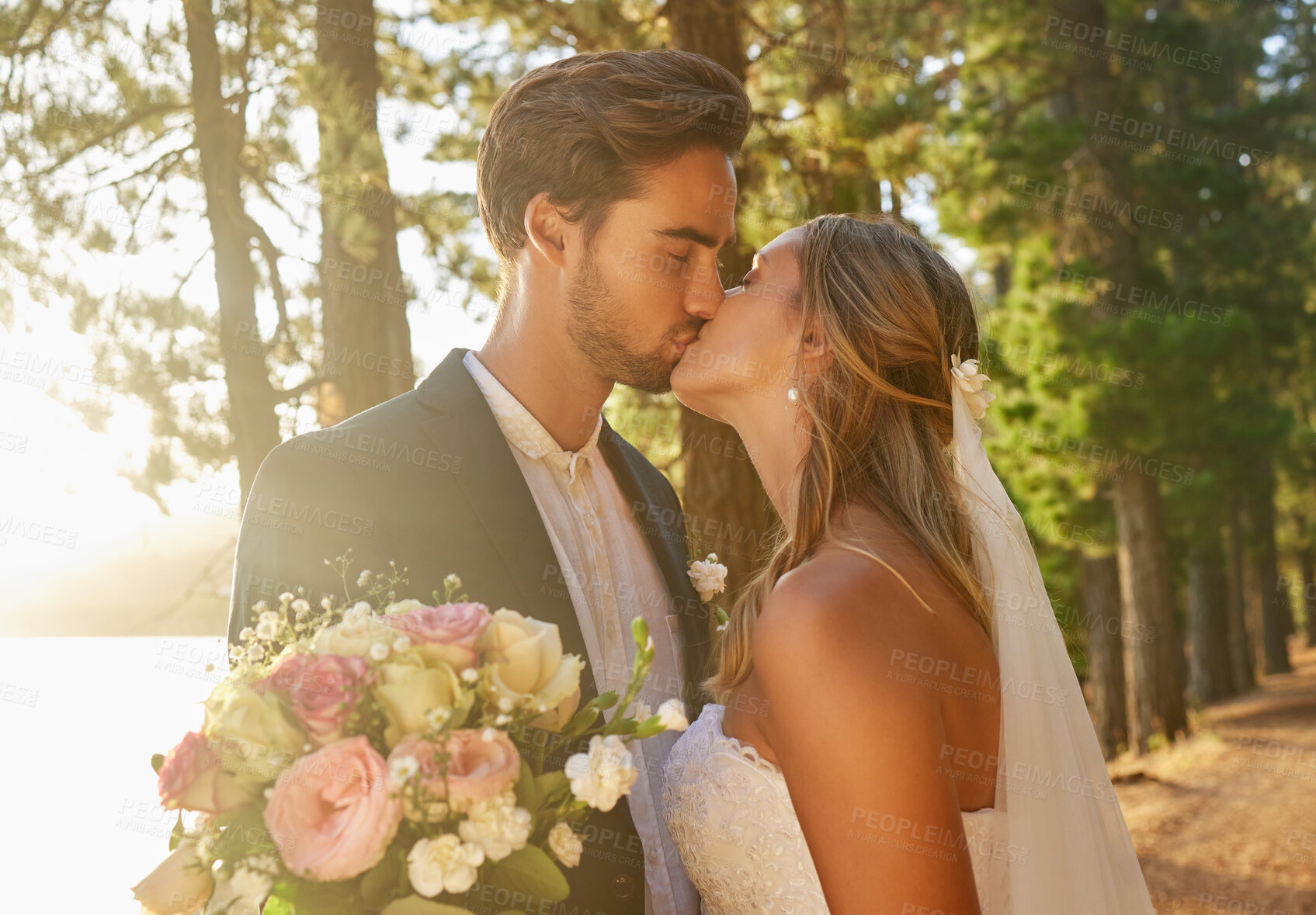 Buy stock photo Wedding, married and couple kiss in park, forest and nature for celebration of love, care and marriage commitment. Bride, groom and kissing in garden for romance, bridal event and celebrate ceremony 
