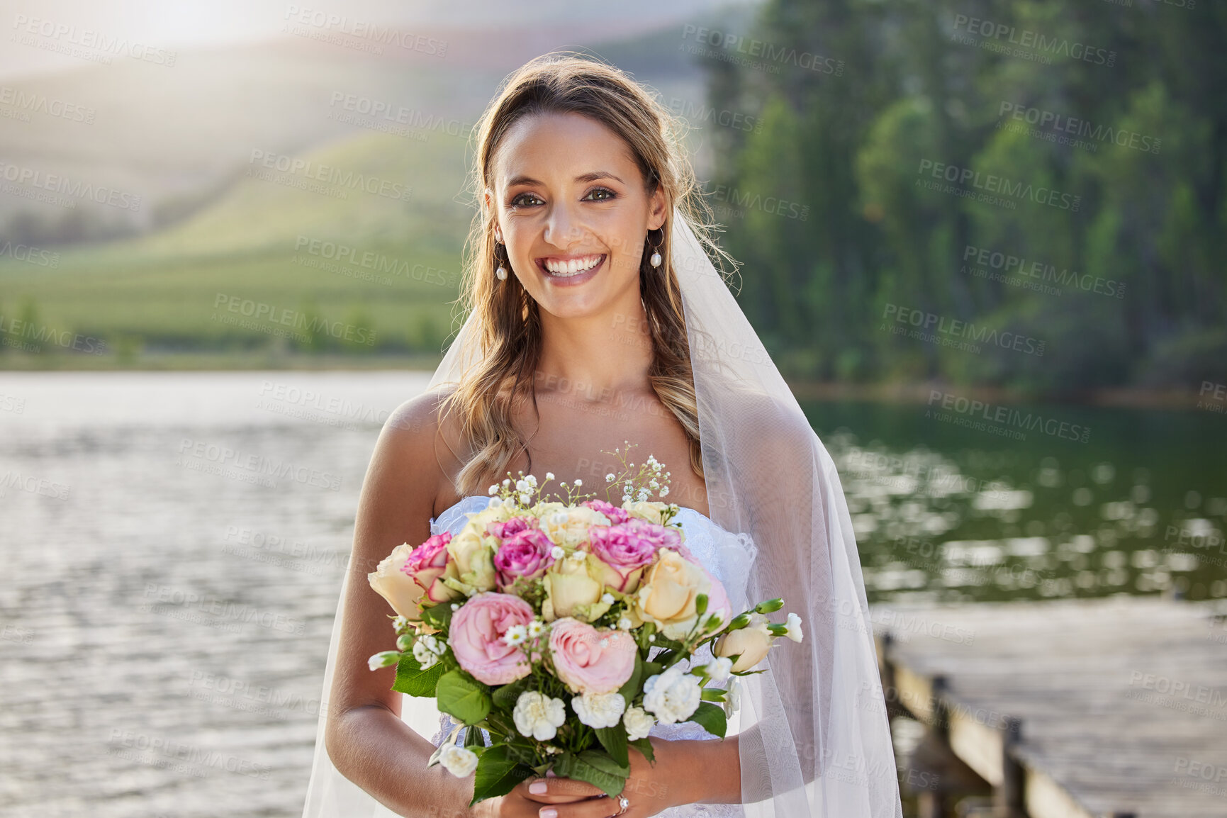 Buy stock photo Portrait, happy bride and bouquet at lake, nature and celebration of commitment, union and marriage. Woman, smile and outdoor wedding of flowers, bridal fashion and excited to celebrate beautiful day