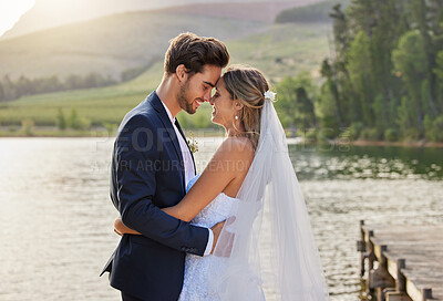 Buy stock photo Cropped shot of an affectionate bride and groom outside on their wedding day