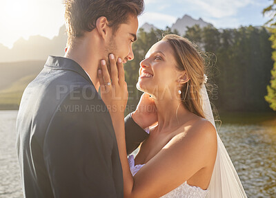 Buy stock photo Wedding, couple and lake water with a bride feeling love, care and support from marriage together. Nature, happiness and romance event of young people with a happy smile from trust and commitment