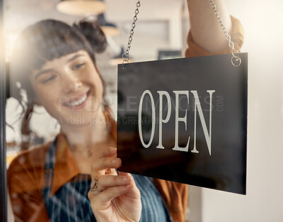 Buy stock photo Shot of a young business owner hanging up an open for business sign
