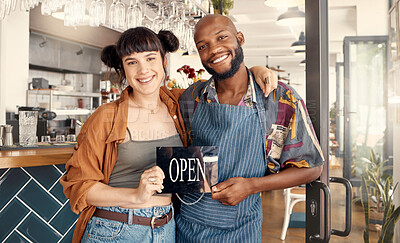 Buy stock photo Shot of two business colleagues holding an open for business sign