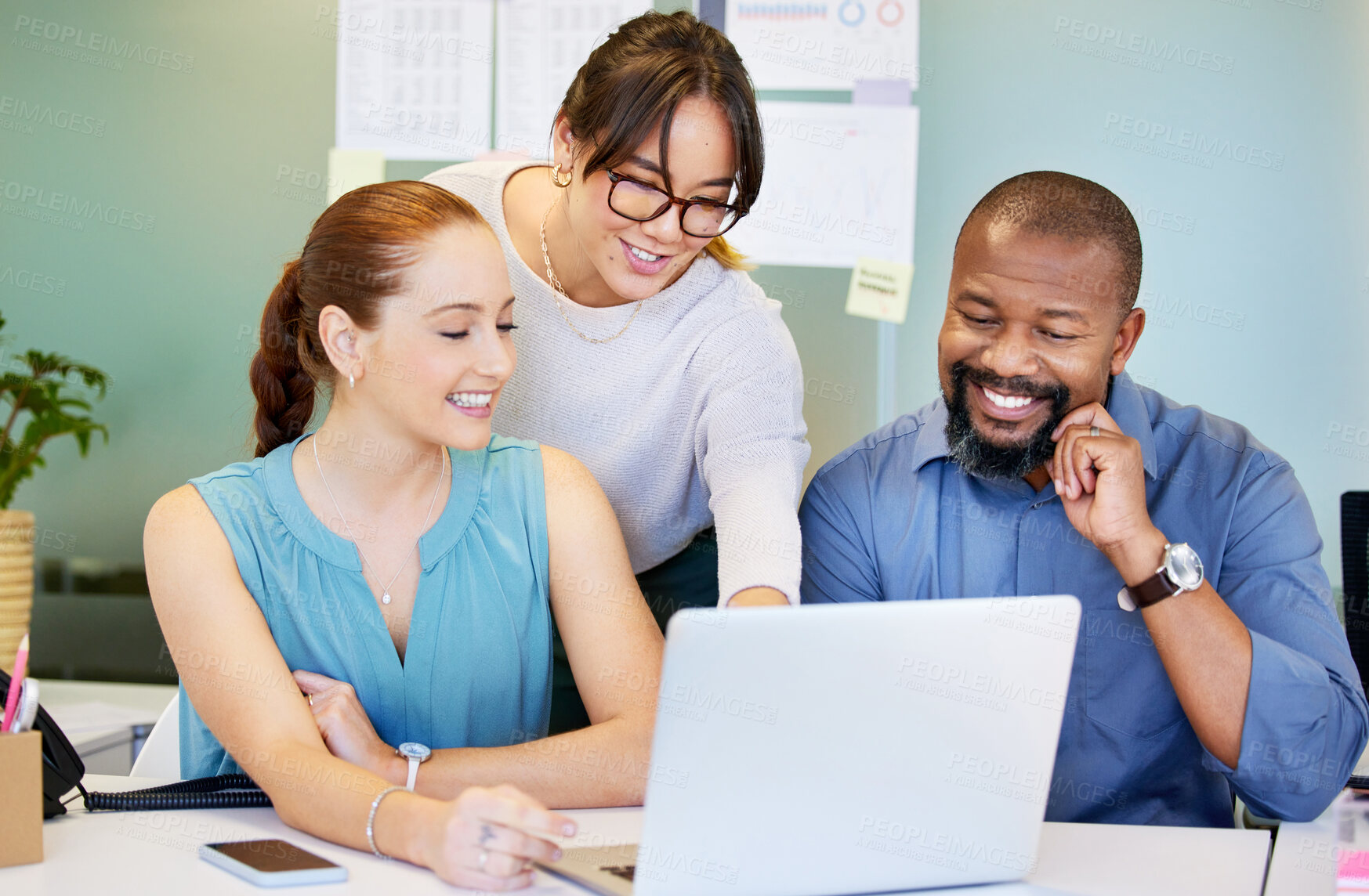 Buy stock photo Shot of a diverse group of businesspeople brainstorming while using a laptop in the office