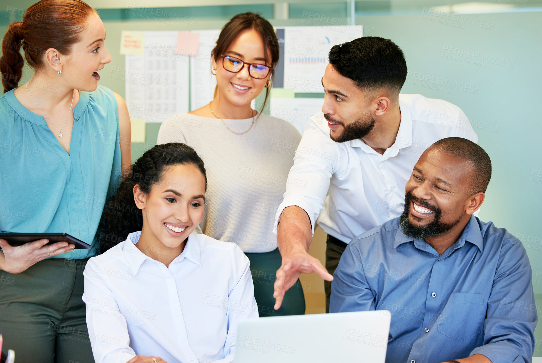 Buy stock photo Shot of a diverse group of businesspeople brainstorming while using a laptop in the office