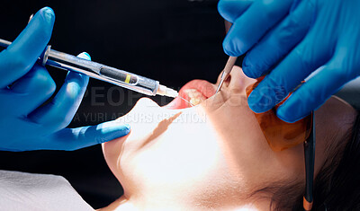 Buy stock photo Shot of a woman receiving an injection at the dentists office