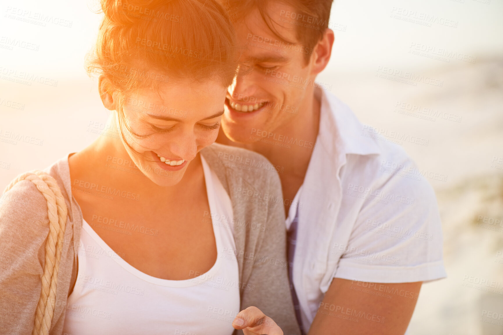 Buy stock photo Couple, beach and laugh at sunrise with love, care and support together with relationship and bonding. Holiday, travel and happy people with weekend break and hug outdoor with vacation and sea