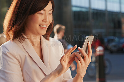 Buy stock photo Happy, phone and business Asian woman in city typing for social media, networking and communication. Professional, smile and person on smartphone for contact, website and internet chat in town