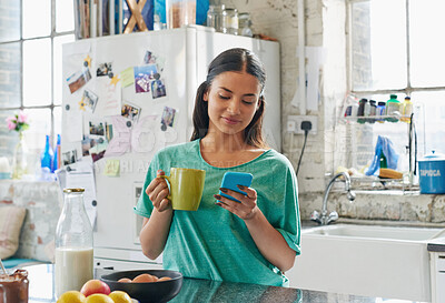 Buy stock photo Phone, coffee or woman in house kitchen for communication or social network on media app in morning. Tea, smile or happy girl on smartphone reading social media news, networking or mobile internet
