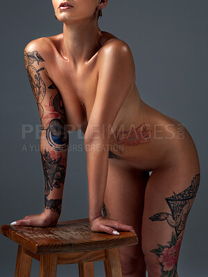Buy stock photo Cropped portrait of a beautiful young woman posing nude on a stool in the studio