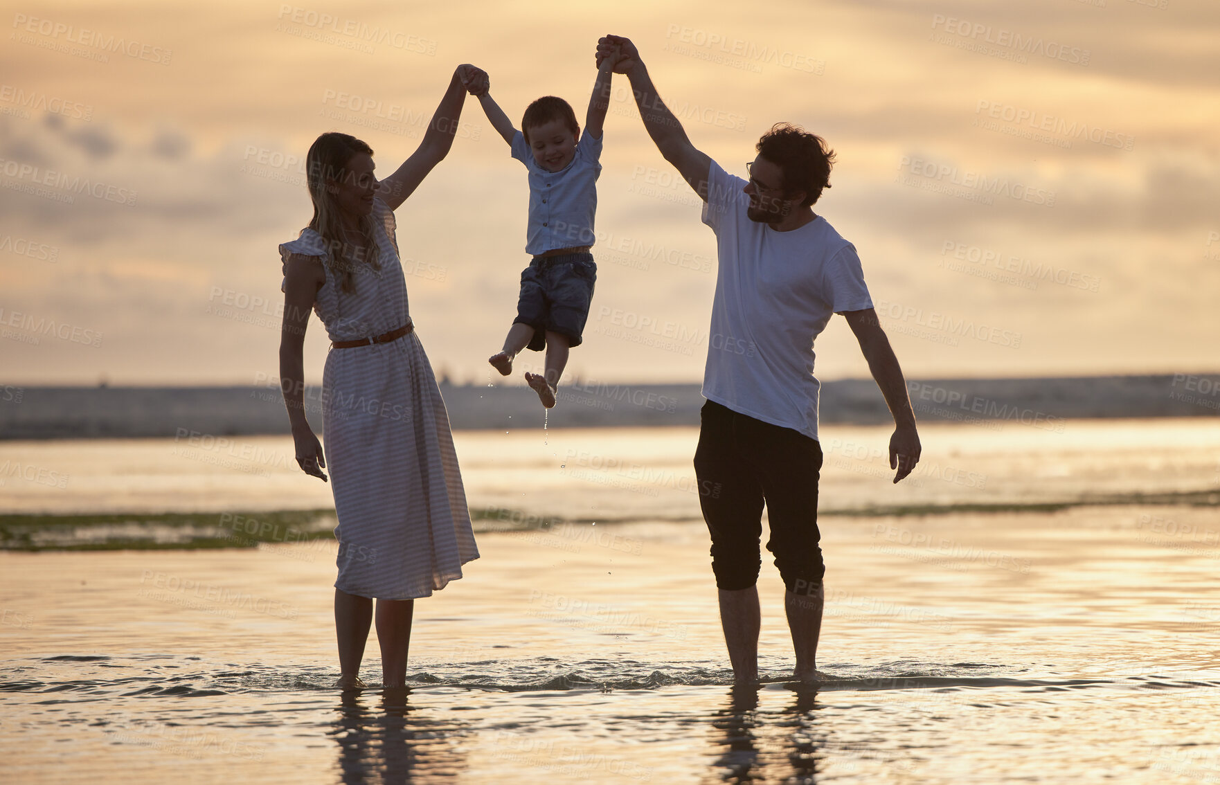 Buy stock photo Beach, sunshine and family holding hands, jump and excited with vacation, adventure and tropical island. Sunset, outdoor and seaside with parents, mother or father with child, kid or playful with joy