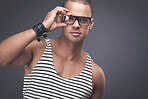 Man fashion model posing against a studio background