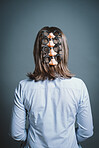 Young woman wearing mask against a grey background in studio