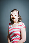 Young woman wearing mask against a grey background in studio