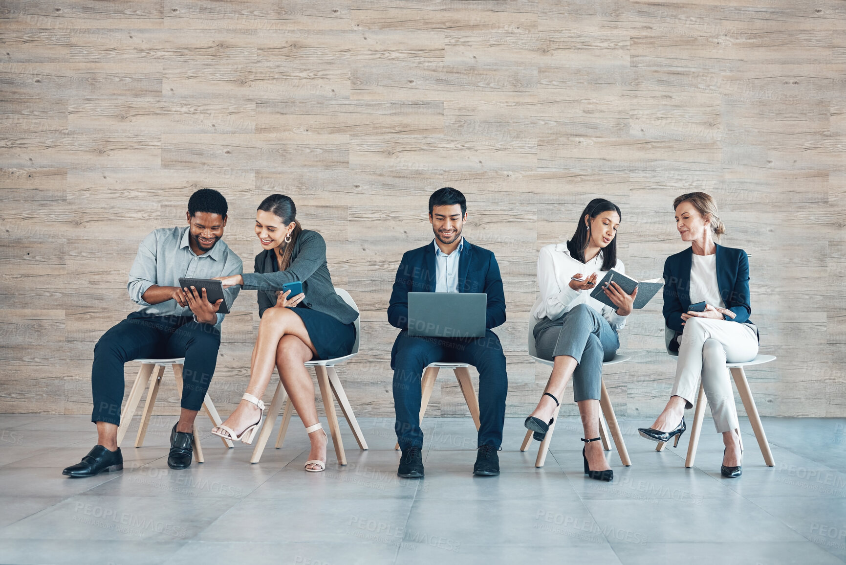 Buy stock photo Business people, recruitment or working on chair with tech for interview, collaboration with onboarding in office. Group, row or corporate company with staff diversity for hr, inclusion or teamwork