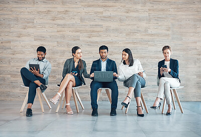 Buy stock photo Business people, recruitment or working in office with tech for interview, collaboration with onboarding on chair. Group, row or corporate company with staff diversity for hr, inclusion or teamwork