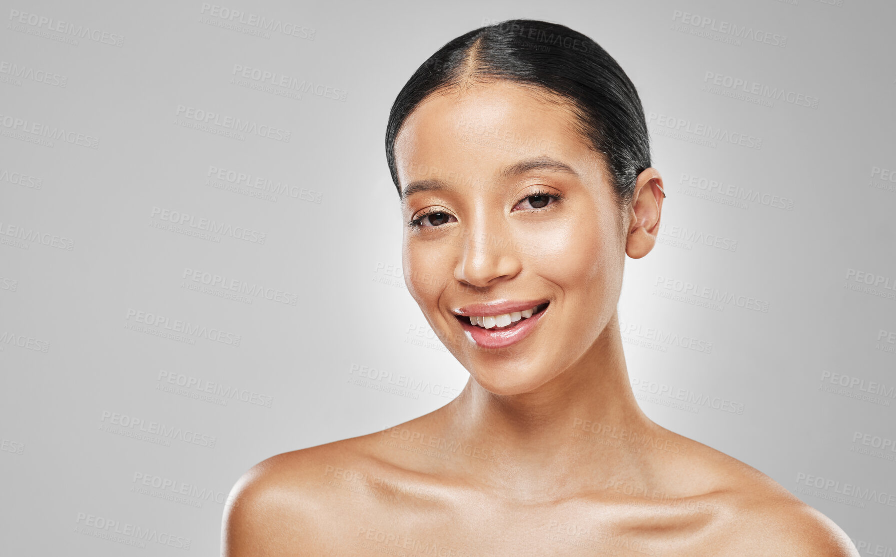 Buy stock photo Studio portrait of an attractive young woman posing against a grey background