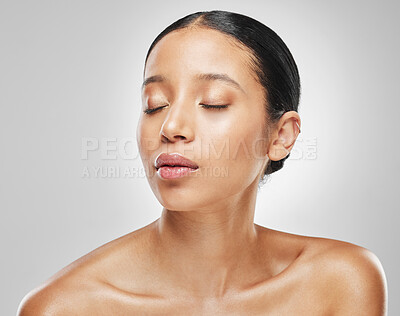 Buy stock photo Studio shot of an attractive young woman posing against a grey background