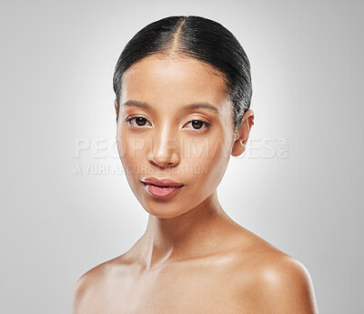 Buy stock photo Studio portrait of an attractive young woman posing against a grey background