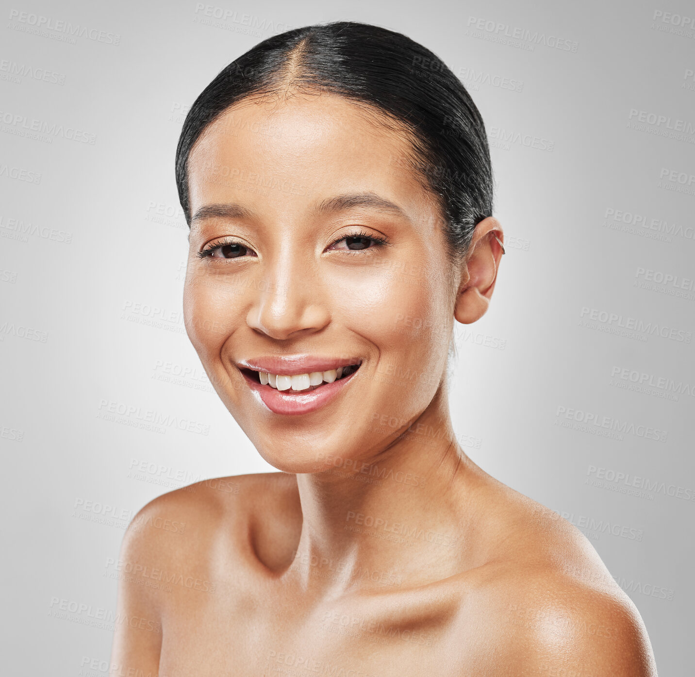 Buy stock photo Studio portrait of an attractive young woman posing against a grey background