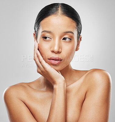 Buy stock photo Studio shot of an attractive young woman posing against a grey background