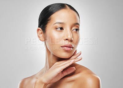 Buy stock photo Studio shot of an attractive young woman posing against a grey background