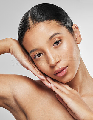 Buy stock photo Studio portrait of an attractive young woman posing against a grey background